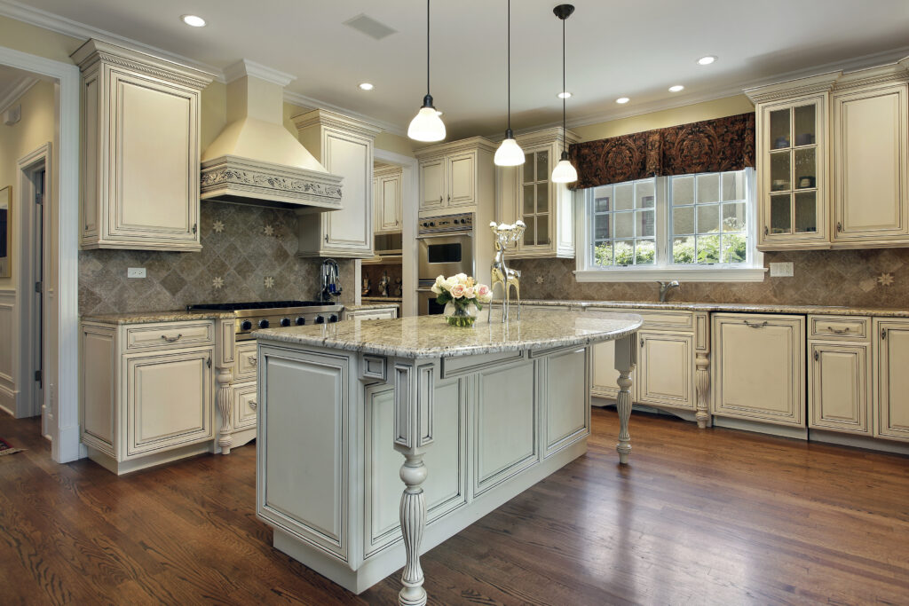 Kitchen in luxury home with large granite island. Everything to Know Before Painting Cabinets