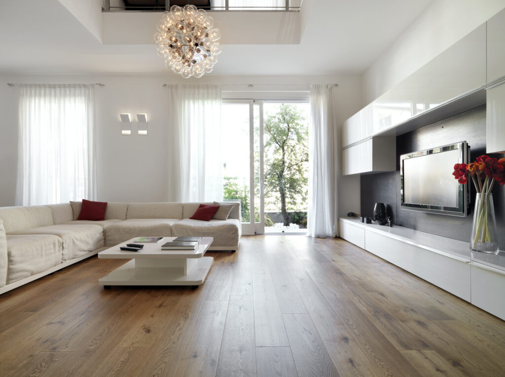 Modern living room with wood floor overlooking the garden. Airbnb Property